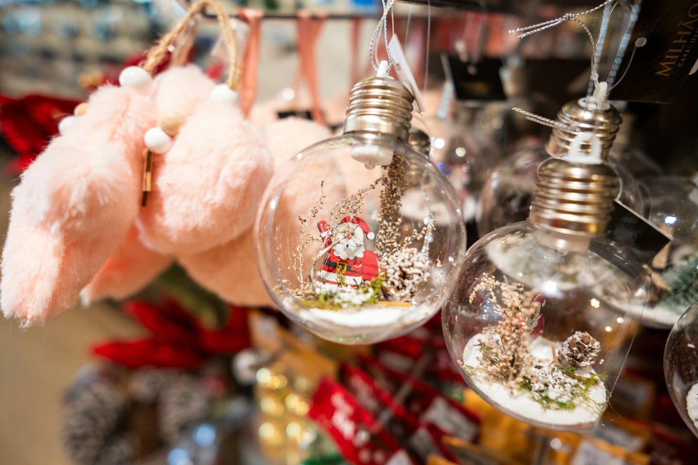 Clear glass Christmas ornaments with Santa and snowy scenes.